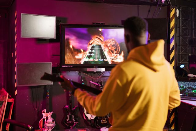 man in a yellow jacket playing Guitar